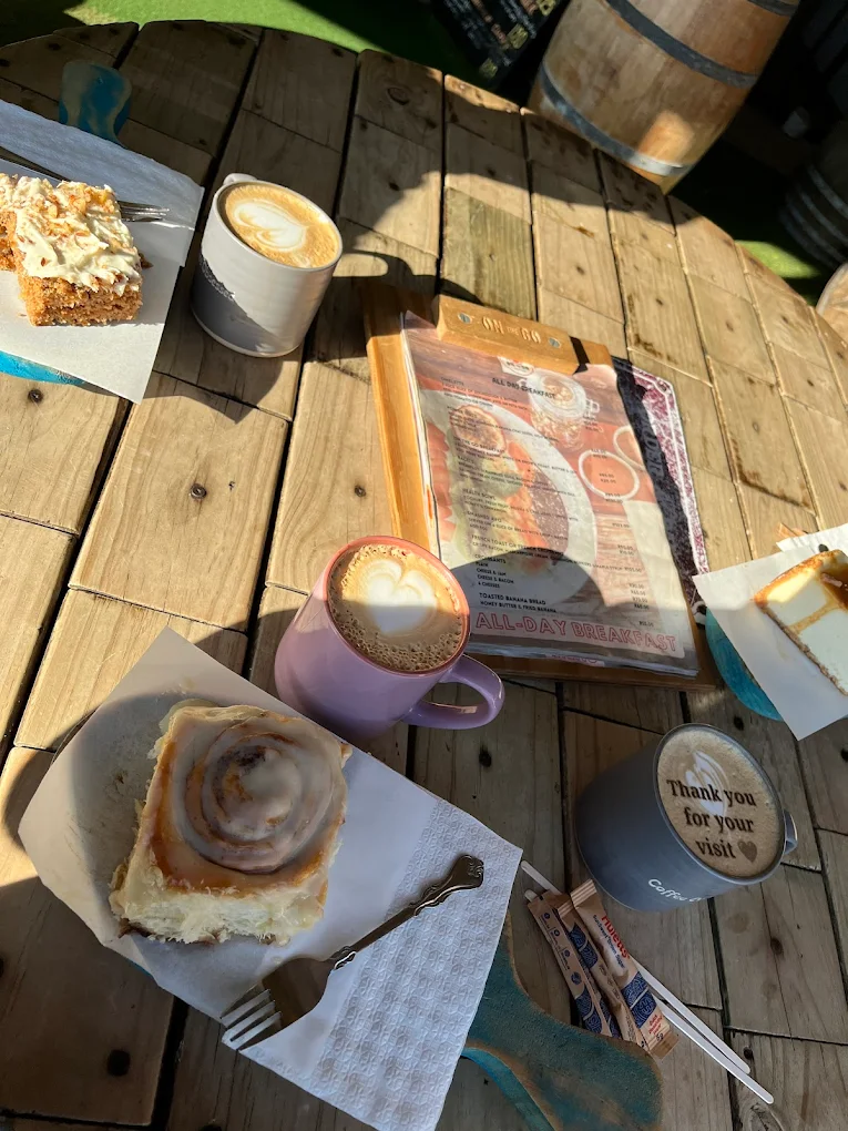 Carrot cake, a cinnamon bun and lattes in the morning sun.